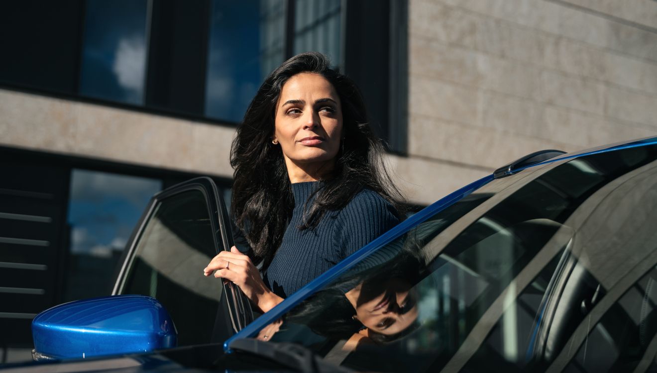 Que dois-je savoir avant d’acheter une voiture ? Femme sortant d'un véhicule Mitsubishi
